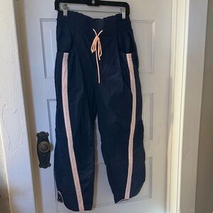 Free People Movement Navy Track Pants with Pink Stripes. Champ is here